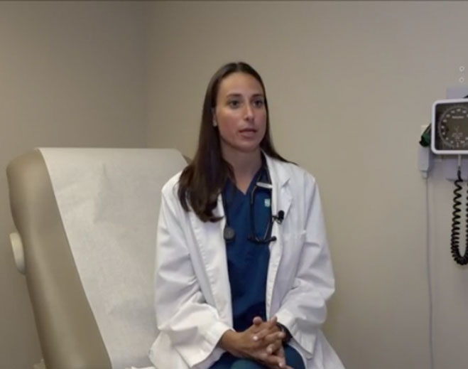 Medical professional seated in exam room